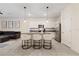 Modern kitchen with white cabinets, granite countertops, and island with seating at 2920 Evergreen Elm Pass, Wesley Chapel, FL 33543