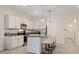 Modern kitchen with white cabinets, granite countertops, and island with seating at 2920 Evergreen Elm Pass, Wesley Chapel, FL 33543