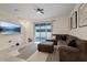 Spacious living room with sectional sofa, large TV, and patio access at 2920 Evergreen Elm Pass, Wesley Chapel, FL 33543