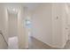 Upstairs hallway with neutral carpeting and access to bedrooms at 2920 Evergreen Elm Pass, Wesley Chapel, FL 33543