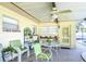 Covered outdoor patio with ceiling fan and seating area at 3613 S Omar Ave, Tampa, FL 33629