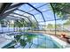 Screened-in pool with mature landscaping for privacy and relaxation at 3613 S Omar Ave, Tampa, FL 33629