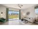 Bright living room with sliding glass doors leading to a patio and pond view at 5013 Gilded Bard Ct, Wimauma, FL 33598