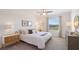 Spacious bedroom with a king-size bed and ample natural light at 5019 Gilded Bard Ct, Wimauma, FL 33598