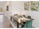 Modern dining area with bench seating and green velvet chairs at 5019 Gilded Bard Ct, Wimauma, FL 33598