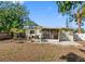 Backyard featuring a screened-in porch, patio, and grill perfect for outdoor entertaining at 538 Southwest N Blvd, St Petersburg, FL 33703