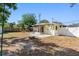 Backyard with a white fence, a sunroom, a patio, and a fire pit at 538 Southwest N Blvd, St Petersburg, FL 33703