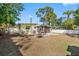 View of the home from the spacious backyard, showing a screened patio at 538 Southwest N Blvd, St Petersburg, FL 33703