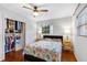Bright bedroom with hardwood floors, ceiling fan, sunny windows, and organized closet at 538 Southwest N Blvd, St Petersburg, FL 33703