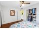 Bedroom features a large organized closet, hardwood floors, ceiling fan, and sunny windows at 538 Southwest N Blvd, St Petersburg, FL 33703