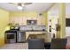 Open kitchen featuring granite countertops, gas range, stainless steel appliances, and bar seating at 538 Southwest N Blvd, St Petersburg, FL 33703