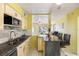 Open kitchen layout with granite countertops, stainless steel appliances, and breakfast bar seating at 538 Southwest N Blvd, St Petersburg, FL 33703