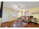 A cozy living room features wood floors, a ceiling fan, and a comfortable sofa at 538 Southwest N Blvd, St Petersburg, FL 33703