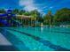 Resort-style pool with clear blue water, slides, and shaded areas for relaxation at 538 Southwest N Blvd, St Petersburg, FL 33703
