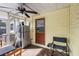 Screened-in sunroom with a refrigerator, a chair, and a doorway to the outside at 538 Southwest N Blvd, St Petersburg, FL 33703