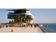 Modern waterfront building with multiple levels and outdoor dining overlooking the water at 538 Southwest N Blvd, St Petersburg, FL 33703