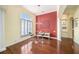 Bright breakfast nook with a red accent wall and hardwood floors at 8478 Dunham Station Dr, Tampa, FL 33647