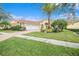 Home exterior with a three-car garage and well-maintained landscaping at 8478 Dunham Station Dr, Tampa, FL 33647