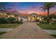 Beautiful two-story home with a three-car garage and brick paver driveway at 8478 Dunham Station Dr, Tampa, FL 33647