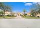 House exterior with a three-car garage and manicured lawn at 8478 Dunham Station Dr, Tampa, FL 33647