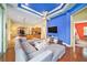 Gathering room with a sectional sofa, large TV, and hardwood floors at 8478 Dunham Station Dr, Tampa, FL 33647