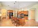 Bright kitchen featuring an island, wood cabinets, and tile flooring at 8478 Dunham Station Dr, Tampa, FL 33647