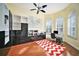 Home office with built-in shelving, hardwood floors, and large windows at 8478 Dunham Station Dr, Tampa, FL 33647