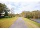 Scenic community path alongside a tranquil lake at 15625 Morning Dr, Lutz, FL 33559