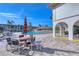 Relaxing pool area with patio furniture and umbrella at 19029 Us Highway 19 N # 3-13, Clearwater, FL 33764