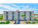 Multi-story building with parking and tropical landscaping at 19029 Us Highway 19 N # 9-301, Clearwater, FL 33764