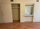 Bedroom with mirrored closet doors and laminate wood flooring at 2255 Philippine Dr # 35, Clearwater, FL 33763
