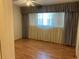 Bedroom with laminate wood flooring, ceiling fan, and window coverings at 2255 Philippine Dr # 35, Clearwater, FL 33763