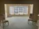Spacious living room with large window and carpeted floor at 2255 Philippine Dr # 35, Clearwater, FL 33763