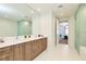 Bright bathroom with dual sink vanity, wood cabinets, and glass enclosed shower at 301 1St S St # 804, St Petersburg, FL 33701