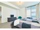 Spacious bedroom with king-size bed, teal accent chair, and city view at 301 1St S St # 804, St Petersburg, FL 33701