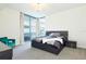 Bright bedroom with a king-size bed, teal armchair and access to a balcony at 301 1St S St # 804, St Petersburg, FL 33701