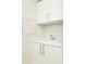White laundry room with sink and cabinets at 301 1St S St # 804, St Petersburg, FL 33701