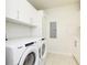 Laundry room with Whirlpool washer and dryer and cabinets at 301 1St S St # 804, St Petersburg, FL 33701