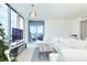 Cozy living room with plush white sectional, a large television, and access to a balcony at 301 1St S St # 804, St Petersburg, FL 33701