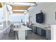 Outdoor kitchen with bar seating and ocean views, equipped with a grill, sink, and refrigeration at 301 1St S St # 804, St Petersburg, FL 33701