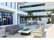 Modern outdoor lounge with comfortable seating, a fire table, and lush landscaping in a condo community at 301 1St S St # 804, St Petersburg, FL 33701