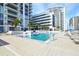 Resort-style pool area with lounge chairs, palm trees, and city skyline views at condo building at 301 1St S St # 804, St Petersburg, FL 33701