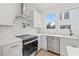 Bright kitchen featuring quartz countertops, stainless steel appliances, and a modern backsplash at 323 15Th N St, St Petersburg, FL 33705