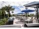 Poolside grilling and seating area with umbrellas at 5025 124Th E Ave, Parrish, FL 34219