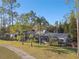 Exterior view of this luxury home nestled in a lush, wooded landscape at 5474 Kemkerry Rd, Wesley Chapel, FL 33543
