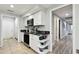 Kitchen area with black countertops, white cabinets, and stainless steel appliances at 5474 Kemkerry Rd, Wesley Chapel, FL 33543