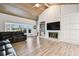 Spacious living room featuring a brick fireplace, wood ceiling, and large windows at 5474 Kemkerry Rd, Wesley Chapel, FL 33543