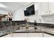 Wet bar with dark countertops, stainless steel sink, and modern faucet at 5474 Kemkerry Rd, Wesley Chapel, FL 33543