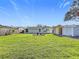 Large backyard with grassy lawn, shed, and circular garden at 5529 11Th N Ave, St Petersburg, FL 33710