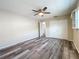 Bright bedroom with wood-look floors, ceiling fan, and double doors to closet at 5529 11Th N Ave, St Petersburg, FL 33710